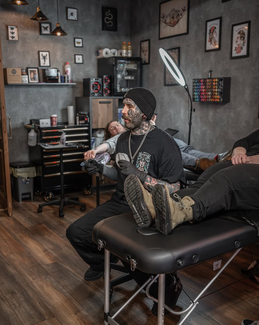 Tattoo artist mid-session in the HellHound studio.